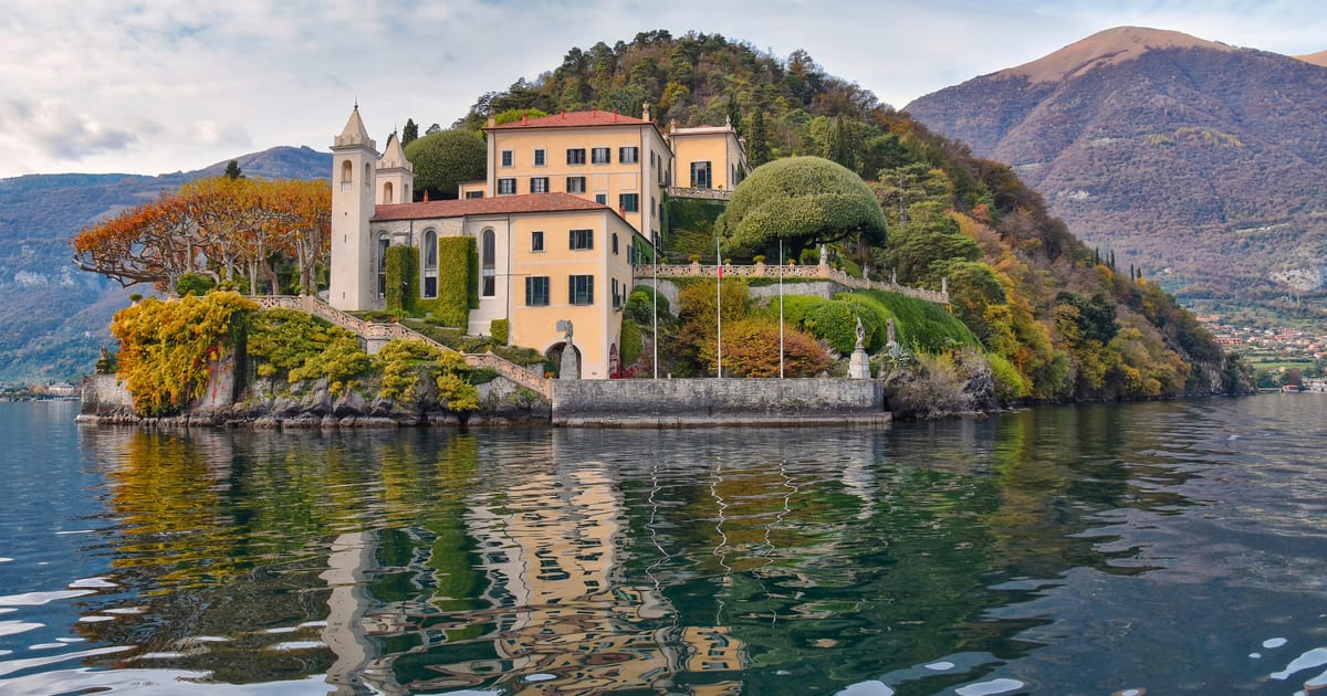 Villa del Balbianello on its wooded point above Lake Como, seen from the water